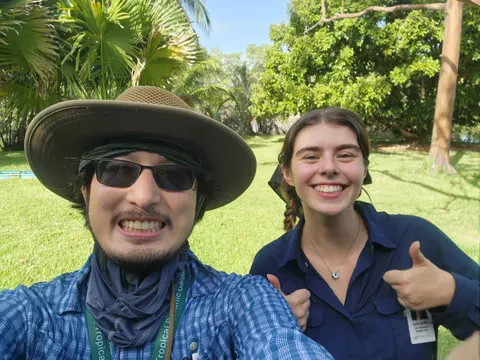 Two lab members give a thumbs-up during fieldwork at Fairchild Tropical Botanic Garden